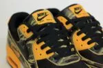 Nike Air Max 90 Premium Black University Gold Camo - Geel/Zwart - Heren/Dames/Uniseks Sneakers - Leer/Mesh - IF1721-001 - Bovenkant